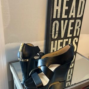 Michael Kors black with gold detail..4.5” wedge size 7.5